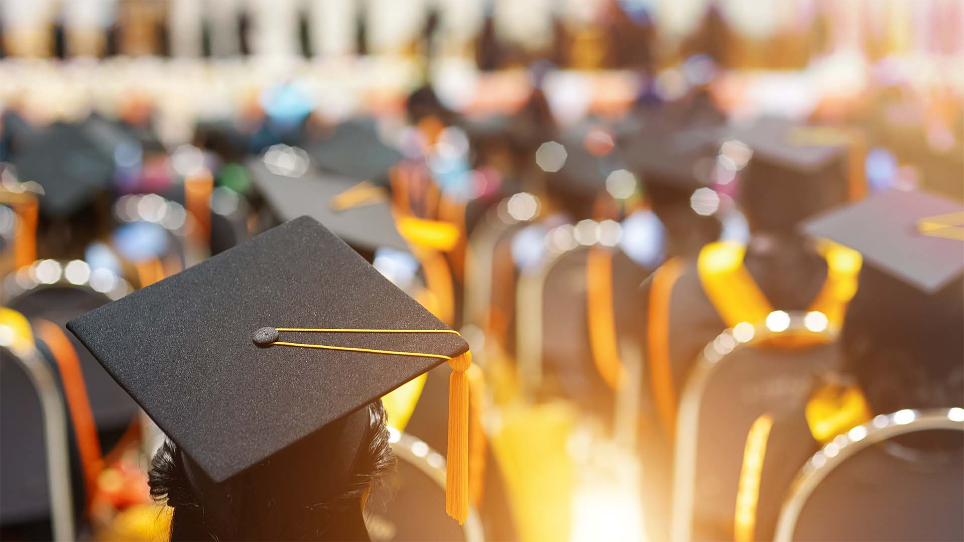 Students wearing cap and gowns at a graduation ceremony