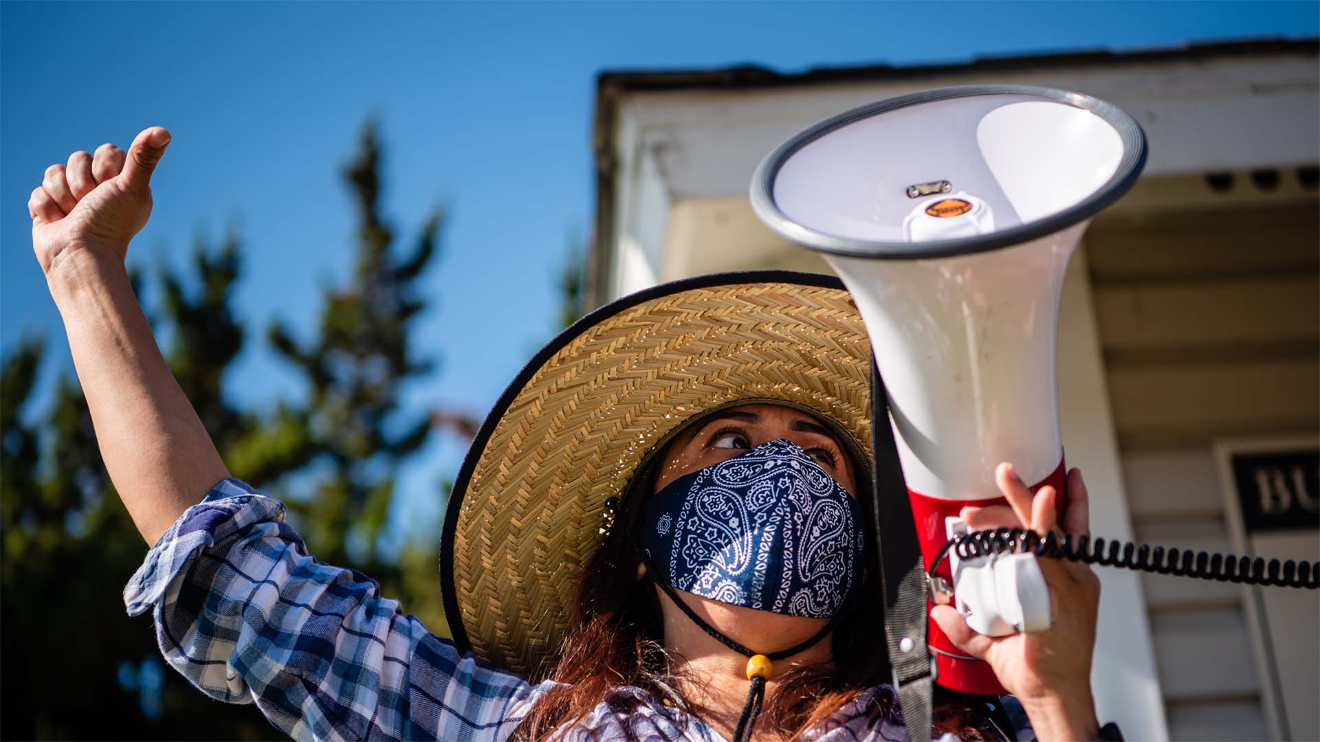 Woman holding a megaphone and raising a fist